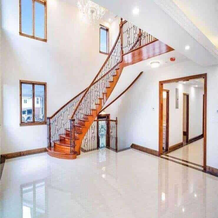 Grand Entryway Tile Flooring with Staircase Detailing